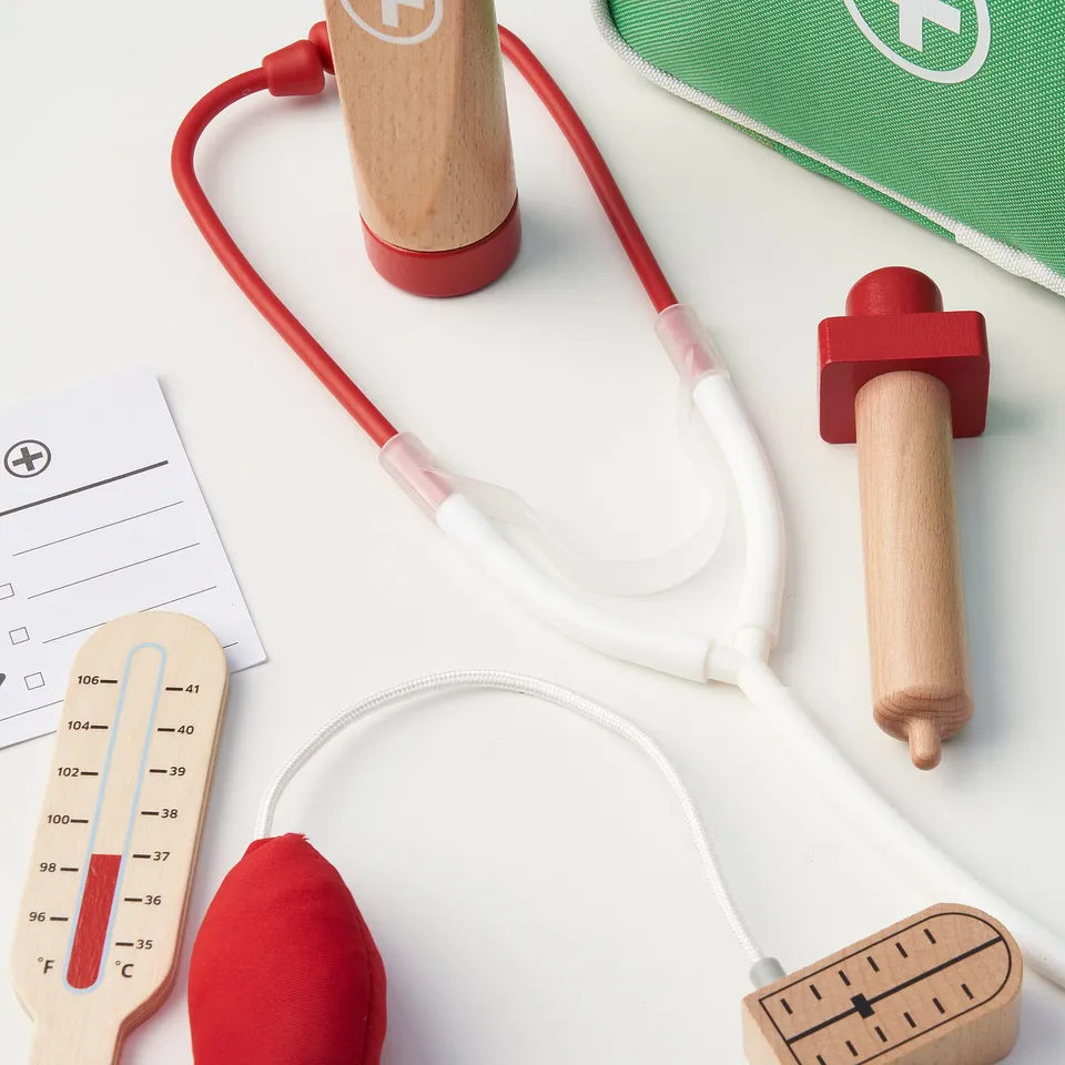 Wooden doctor play set with stethoscope, thermometer, syringe & bag, ideal for imaginative role-play, enhancing empathy and communication skills.