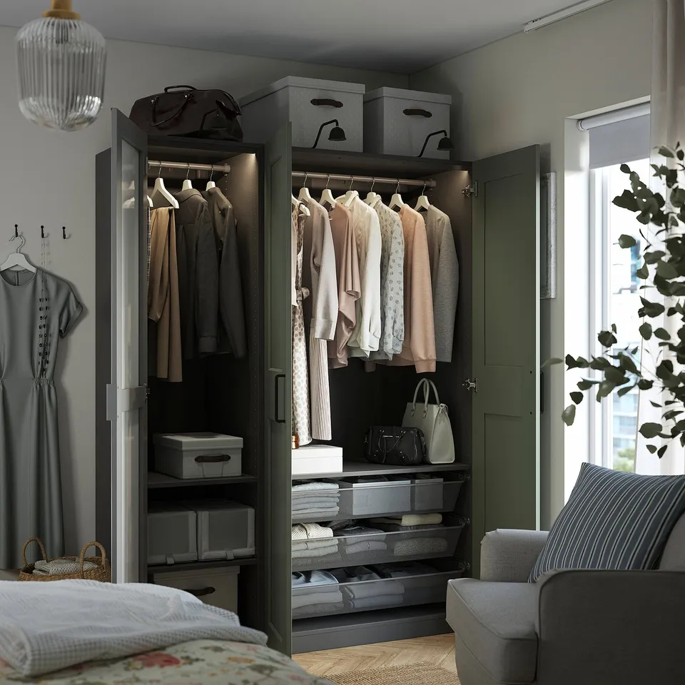Modern bedroom with PAX wardrobe, mirror enhancing space.