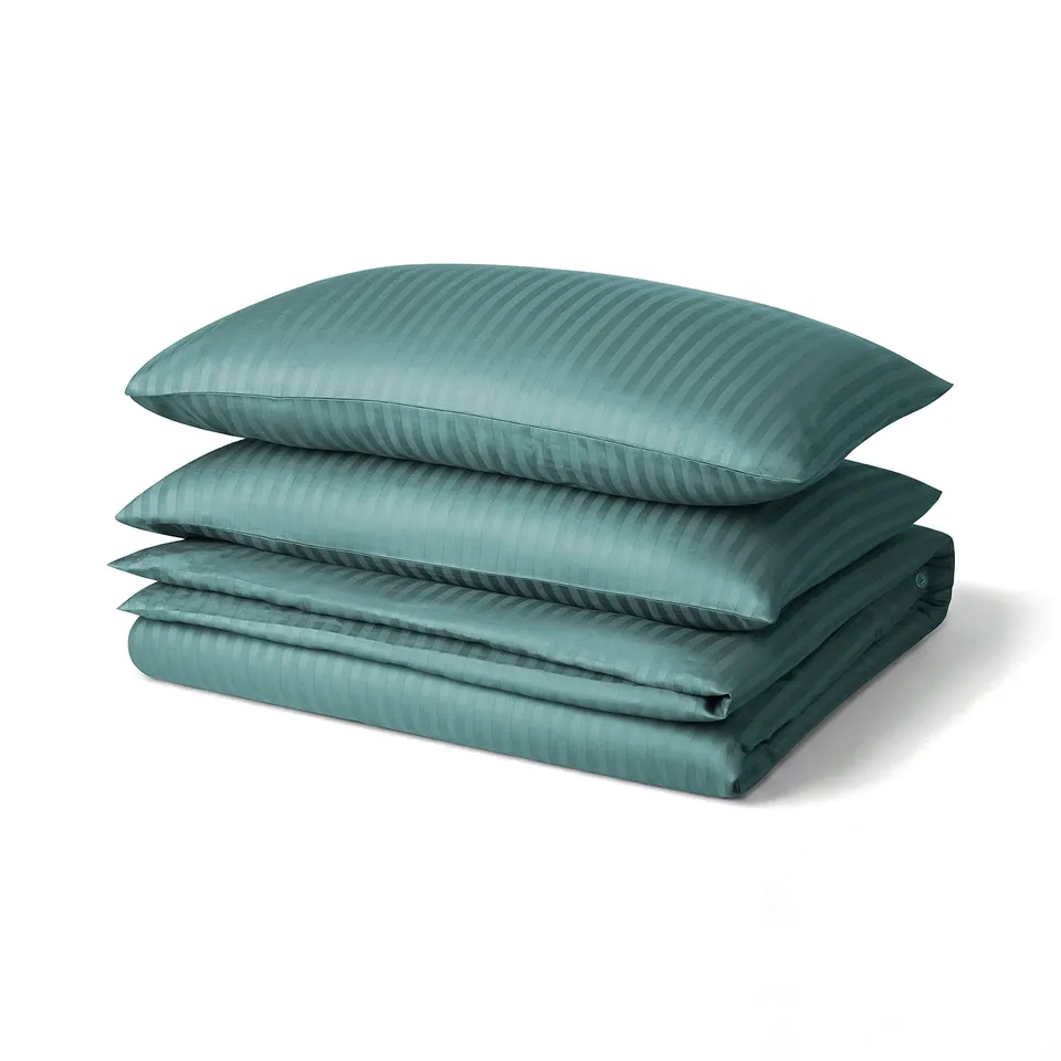 Teal bedding set with striped pattern, featuring duvet cover and pillows with envelope closure. Soft, lustrous fabric made from cotton and lyocell.