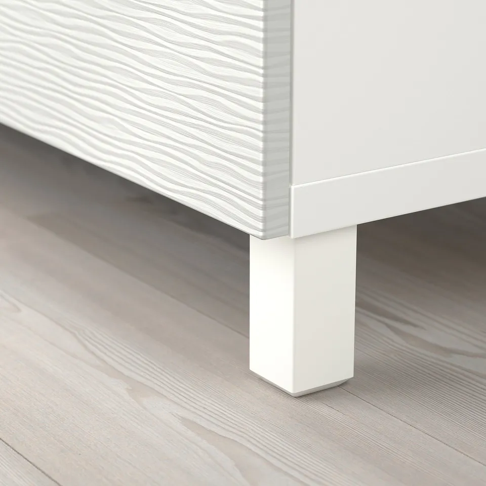 Close-up of white BESTÅ furniture leg, showing sturdy design and smooth edges.