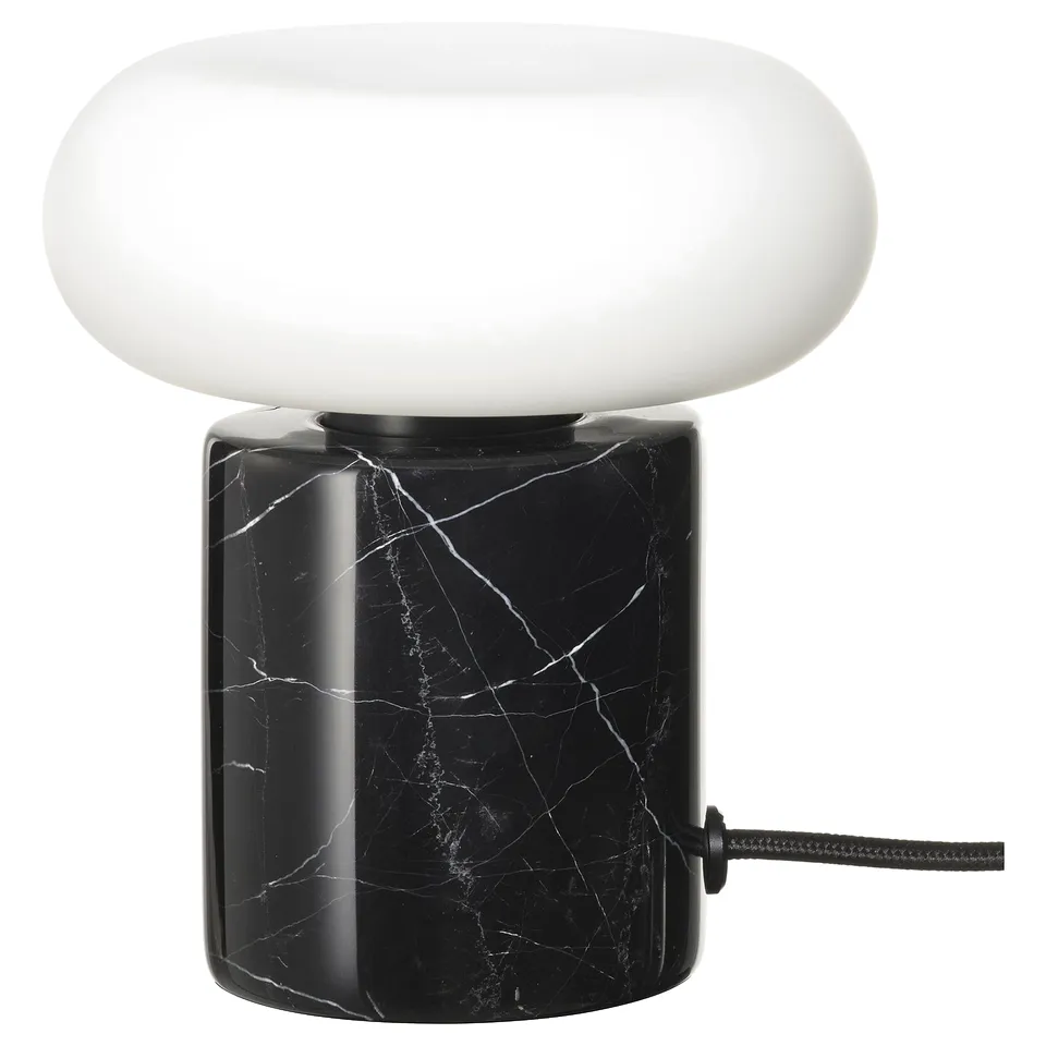 Modern table lamp with black marble base and frosted white glass shade.