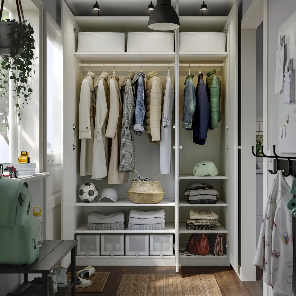 Organised closet showing clothes, accessories, and storage shelves.