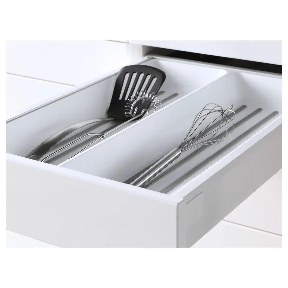 White kitchen drawer with utensils, featuring self-closing mechanism and smooth-glide functionality.