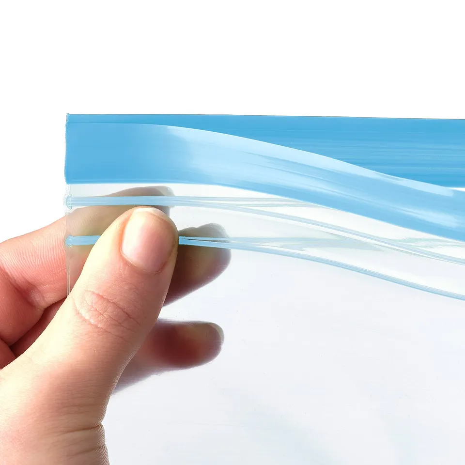 Hand holds blue reusable ISTAD bag, showing its durable, leakproof seal.