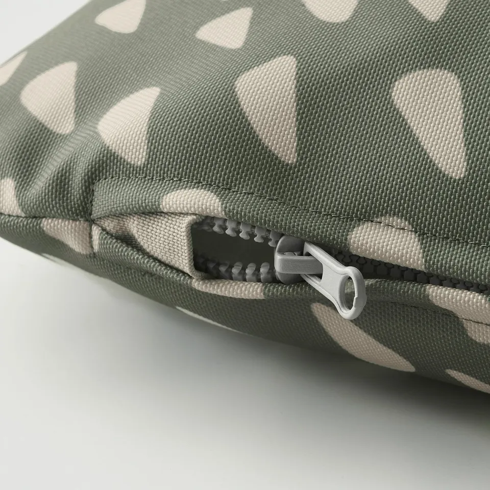 Green and beige patterned pet cushion with durable, washable fabric and sturdy zip.
