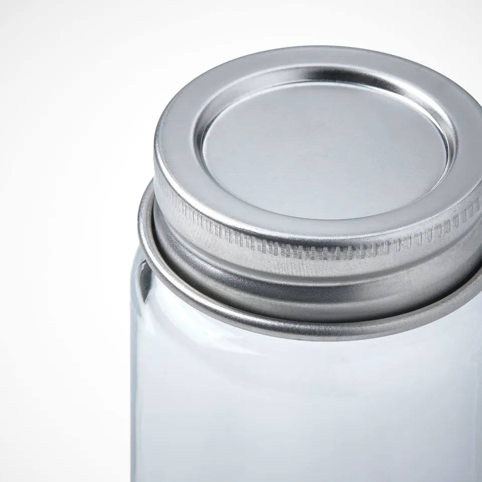 Metal-lidded glass jar for storing herbs and spices.