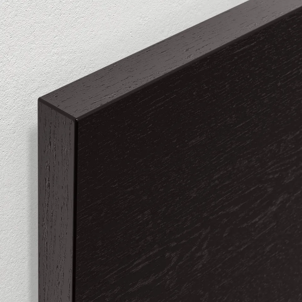 Close-up of sleek, black wooden furniture with smooth, polished edges, showcasing high-quality finish and craftsmanship.