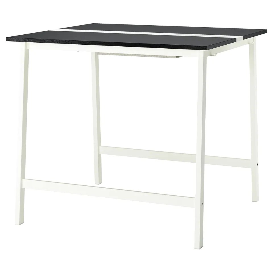 The MITTZON table a sleek black surface atop a white metal frame, combining modern simplicity with practicality for easy cleaning.