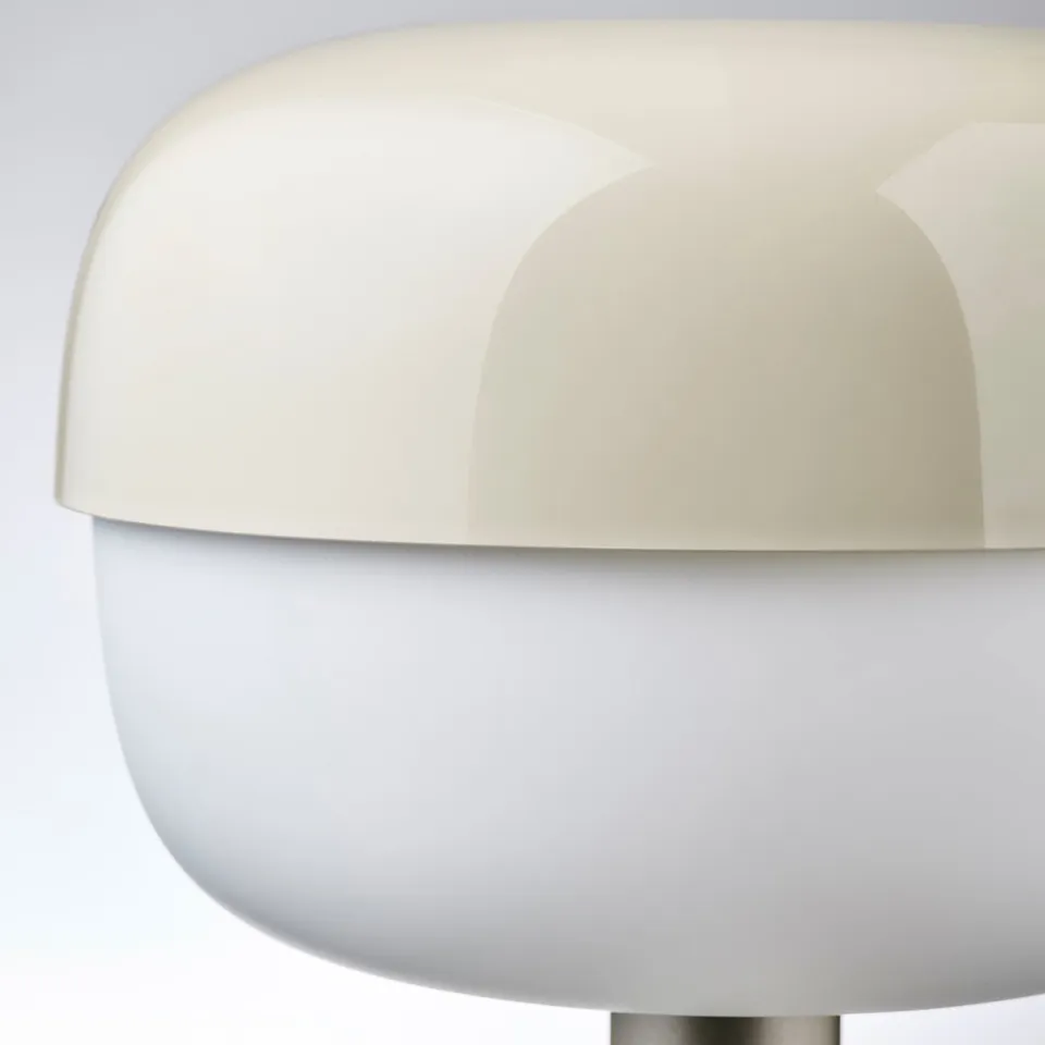 Modern table lamp with sleek, curved design providing soft lighting.