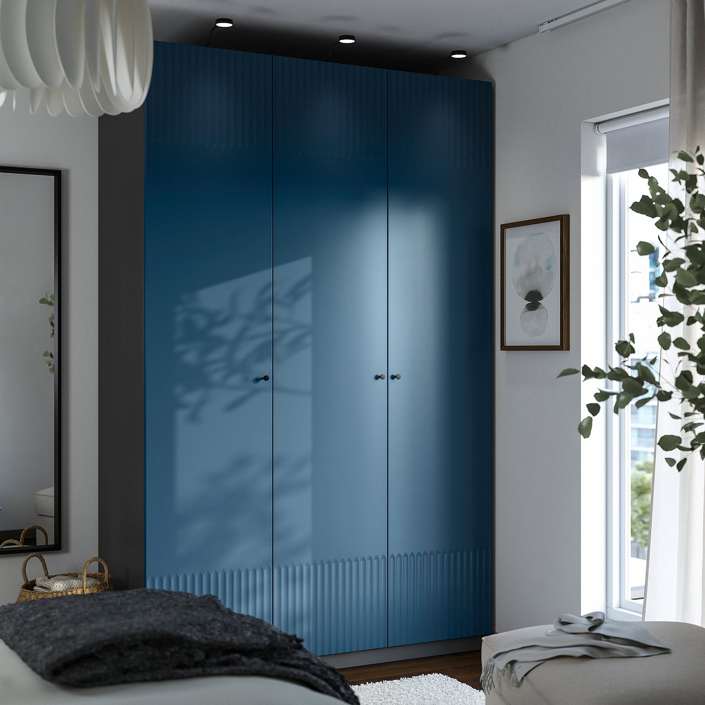 Modern blue PAX wardrobe with reflective doors, large and tall, fits seamlessly in bright room with plants and minimalist decor.