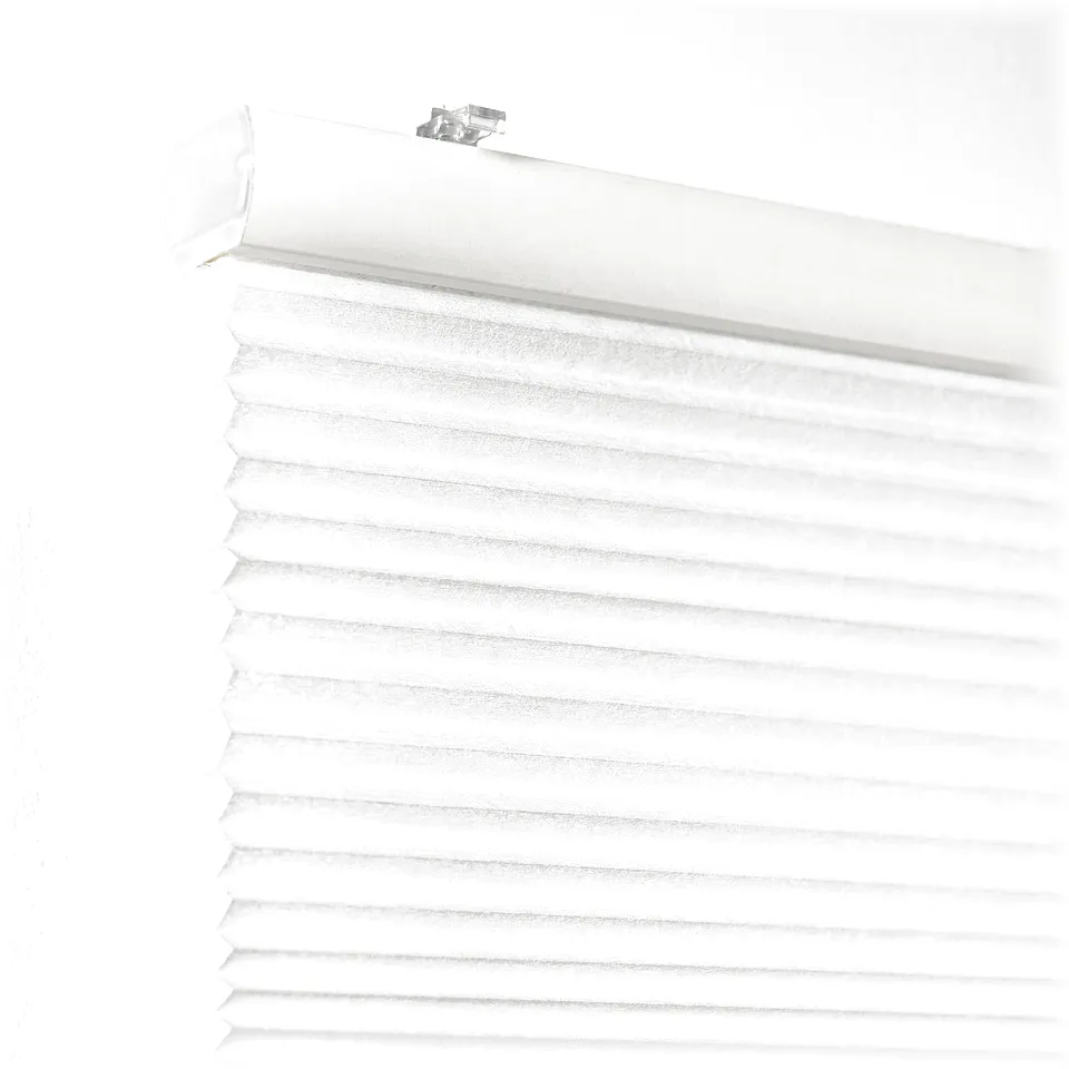 White cellular blind mounted on white wall, partially pulled down for privacy and light control.
