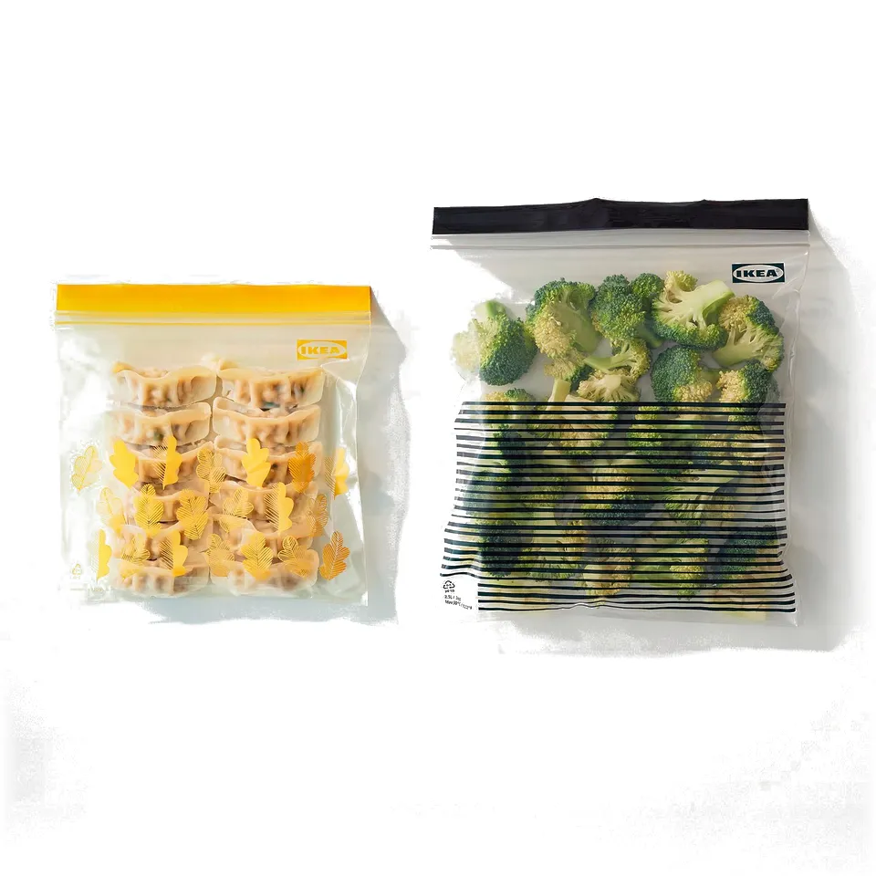 Two zip bags: one filled with dumplings, the other with broccoli and green beans.