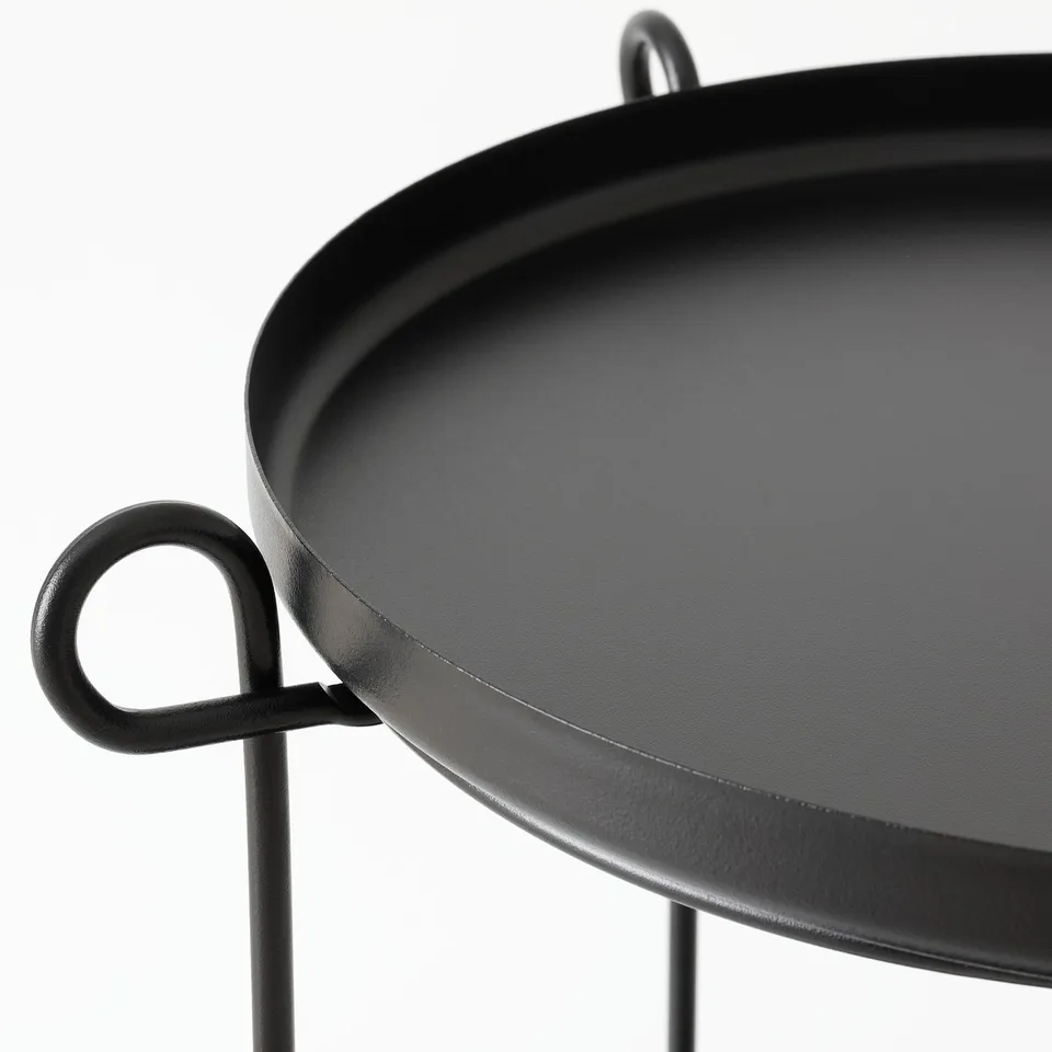 Modern black side table with two removable trays, supported by sturdy, minimalist metal legs.
