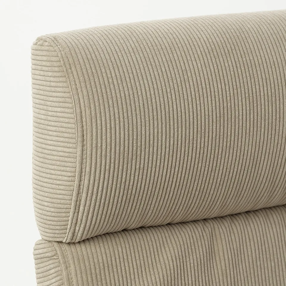 Close-up of POÄNG chairs cushioned back and seat, showing textured beige corduroy with vertical lines, offering comfort and durability.