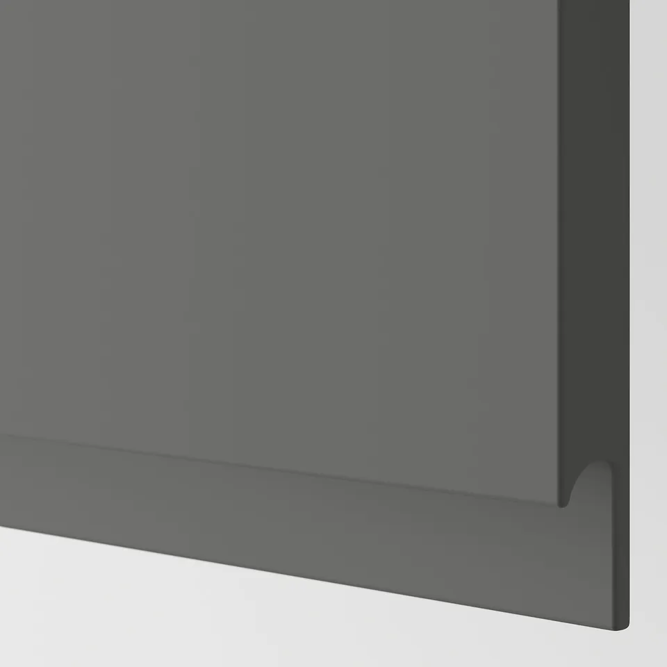 Dark grey kitchen cabinet close-up; smooth, sleek finish with integrated handle; high-quality, modern design.