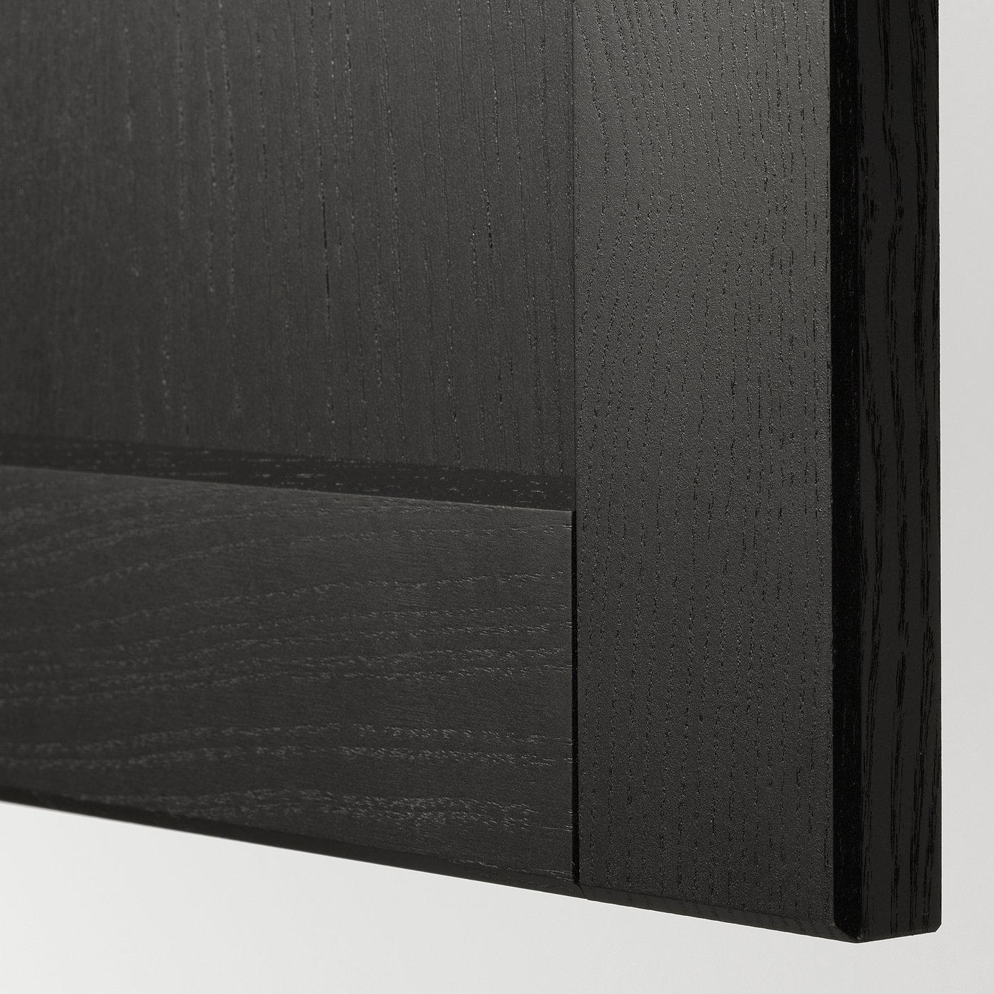 Close-up of sleek, dark wood finish on a modern kitchen cabinet, showcasing smooth texture and bevelled edges.