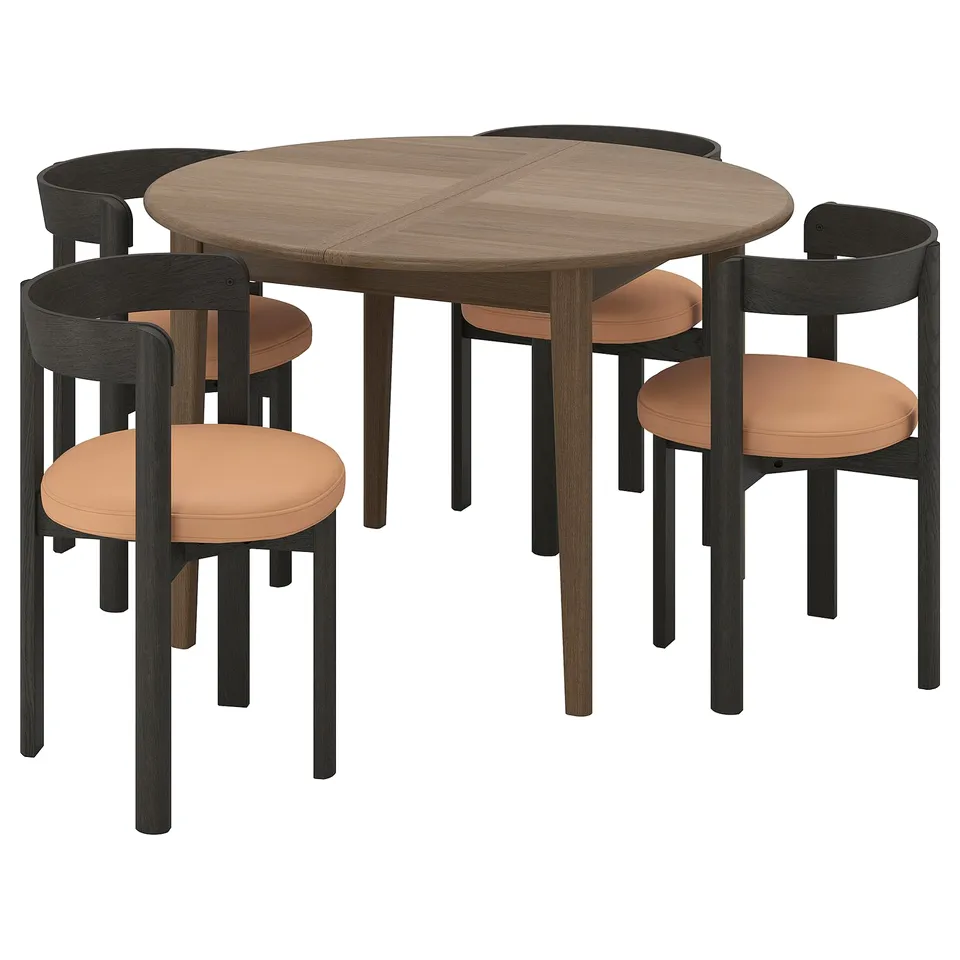 SKANSNÄS dining set: round table with four chairs. Dark wood table, orange chairs with upholstered seats. Modern minimalist design.