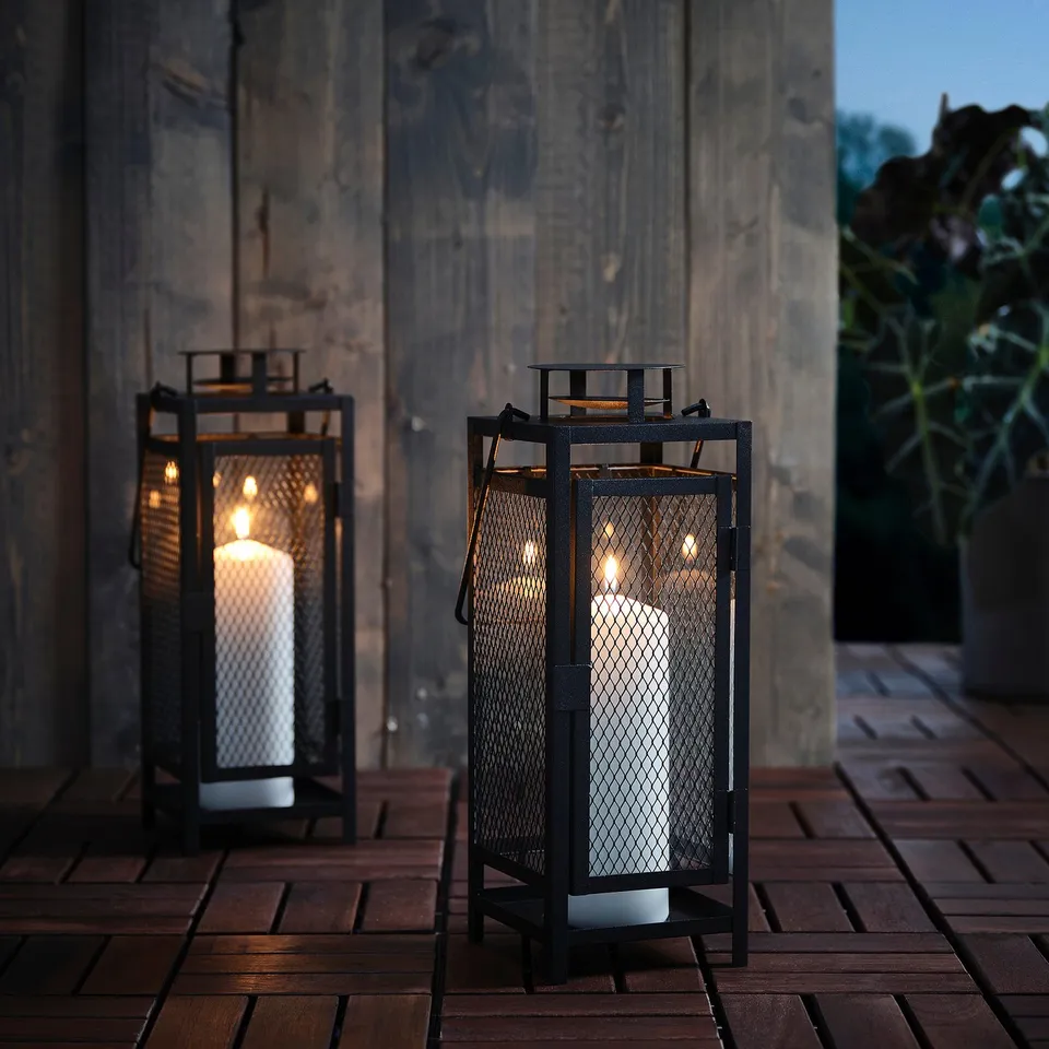 Black metal lanterns with candles. Lights up inside and out, creating a warm, country feel. Suitable for indoor and outdoor use.
