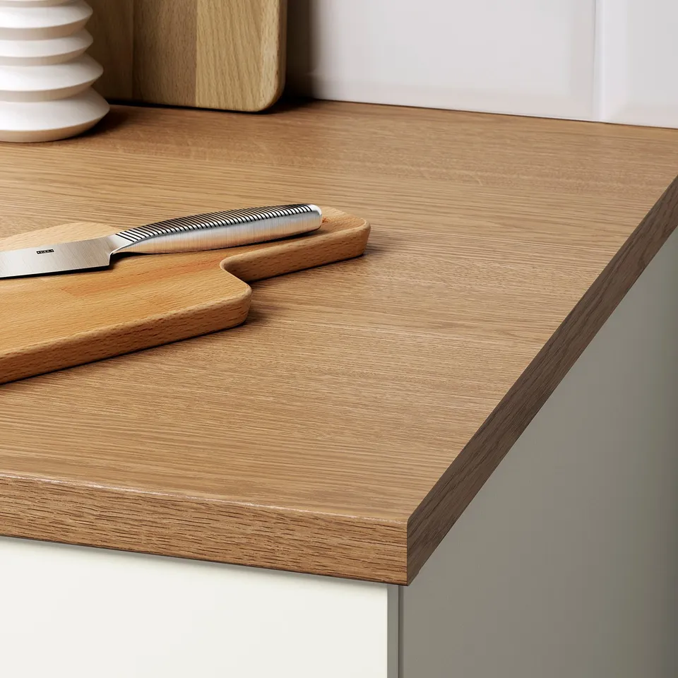 Wooden kitchen countertop with knife, cutting board, and stackable plates. Easy to clean and durable.