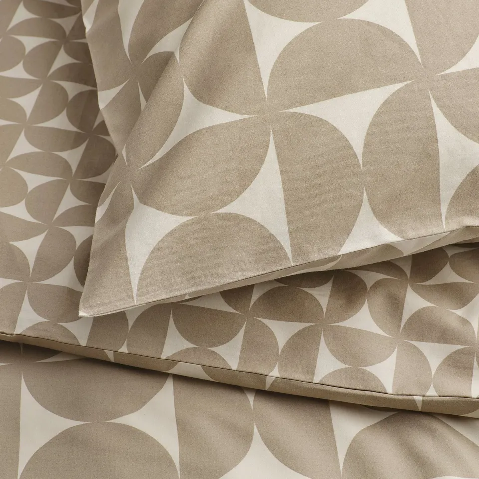 Folded bedding with geometric patterns, soft texture, crisp details.