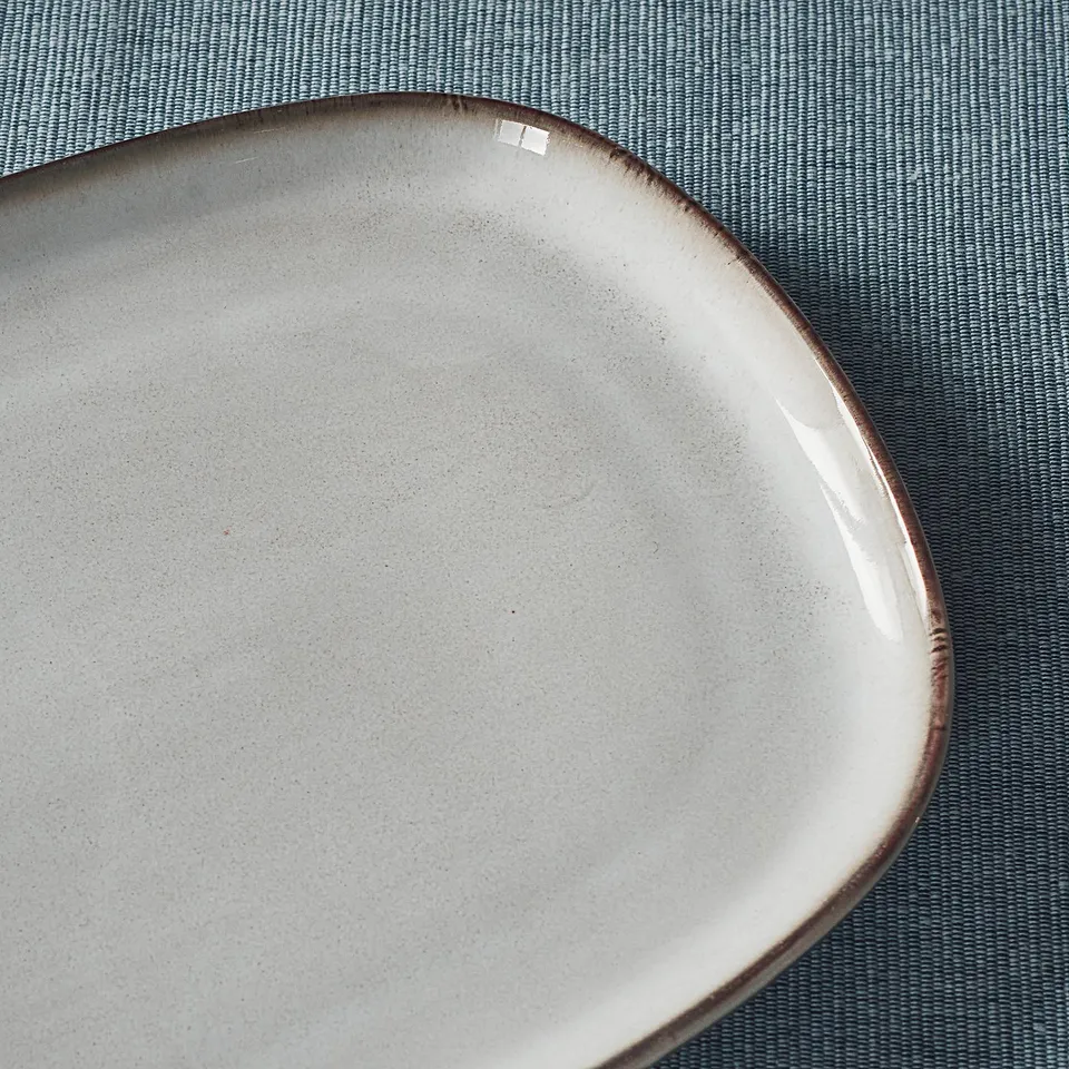 Grey plate on cloth.