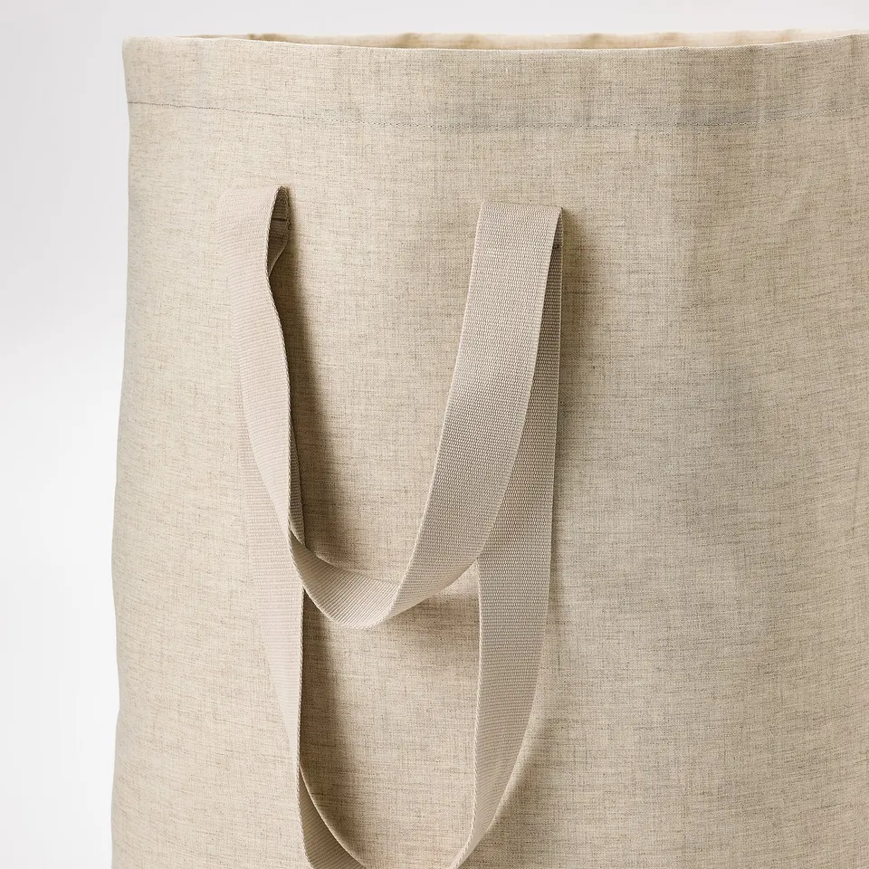 Close-up of eco-friendly laundry tote handles, made from recycled materials, showcasing sturdy and durable design.