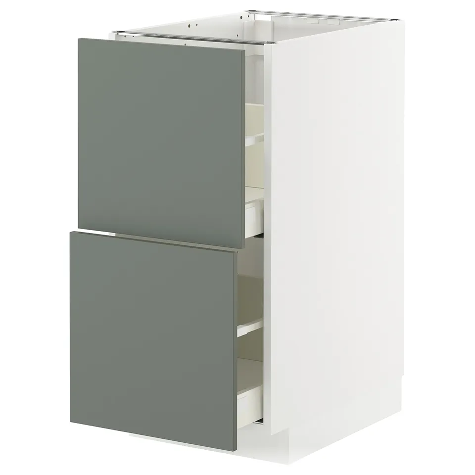 Modern kitchen cabinet with grey-green drawers and white frame.