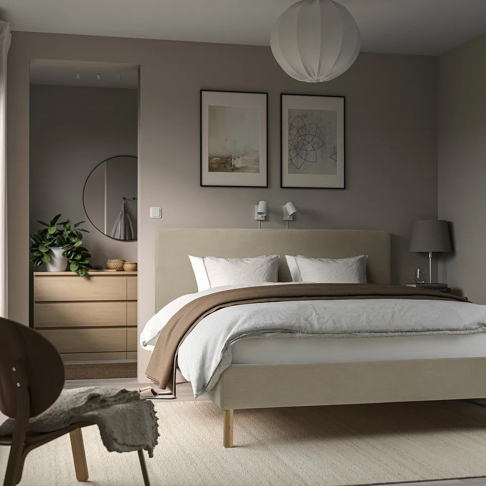 Modern bedroom with TÄRNKULLEN bed, art, pendant lamp, wood chair & dresser, grey rug.