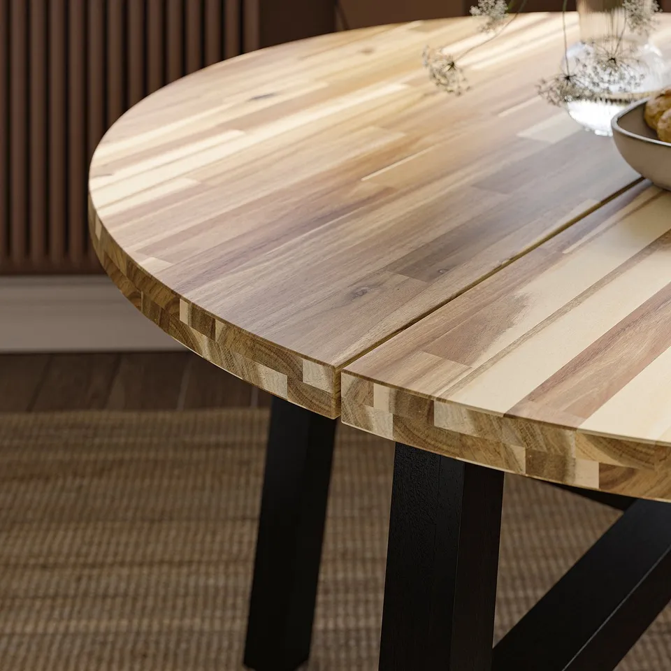 Close-up of a wooden table with intricate grain patterns and sturdy black legs, showcasing its high-quality craftsmanship.