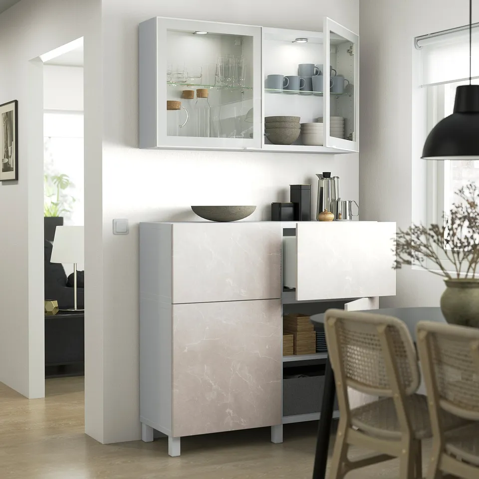 Modern kitchen with BERGSVIKEN cabinet, marble doors, metal legs, glass cabinet with dishes, black pendant light, wooden floor.
