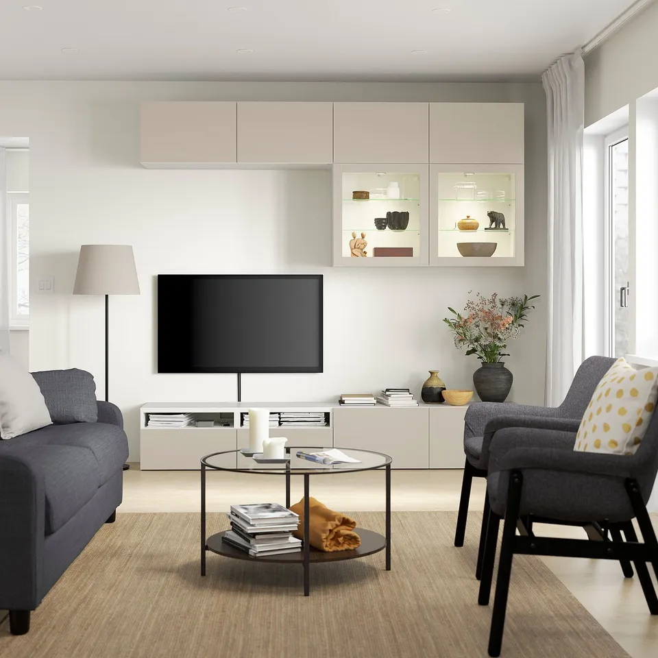 Modern living room with LAPPVIKEN light grey-beige storage units, flat-screen tv, grey couch, and patterned chair.