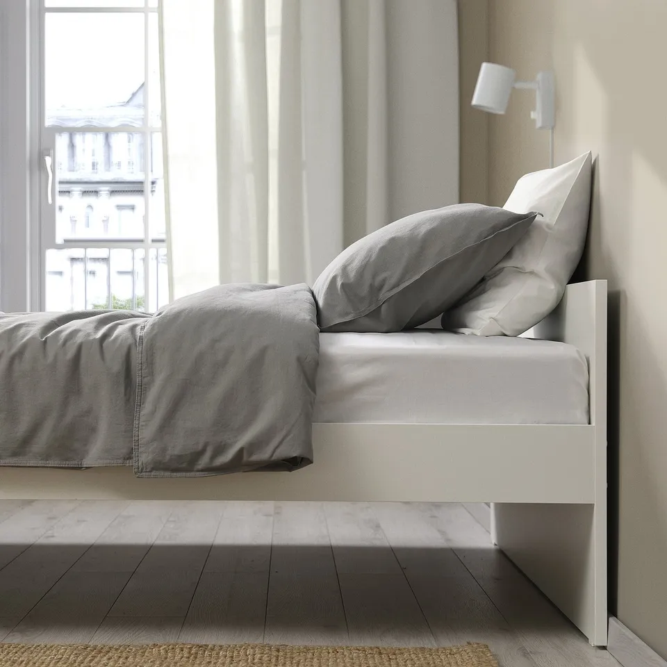 White VIHALS bed frame with city view