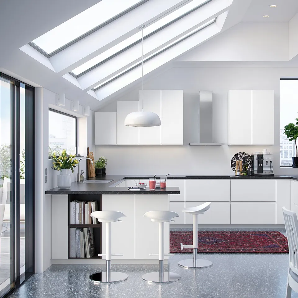 Modern white minimalist kitchen with sleek cabinets, island, skylights, and stools.