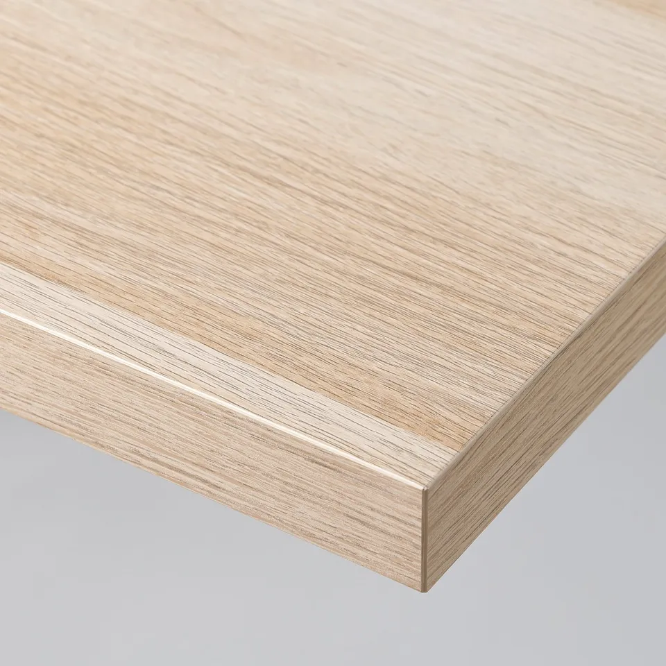 Close-up of a smooth, light wooden tabletop with a clean, finished edge.