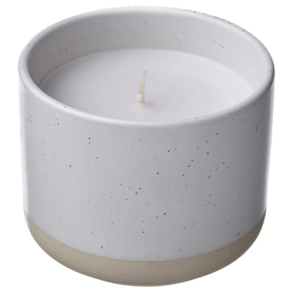 JÄMLIK candle: white ceramic, speckled, cylindrical with vanilla scent.