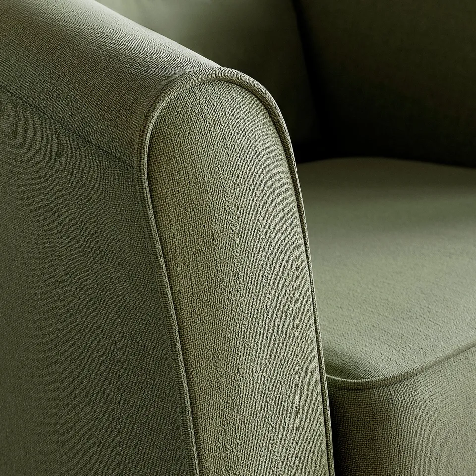 Close-up of a TULLSTA armchair, showcasing high-quality, textured fabric with smooth, rounded edges, emphasising comfort and modern design.
