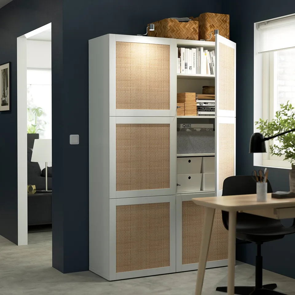 A modern storage unit with adjustable shelves and soft-close doors, displaying books and office supplies.
