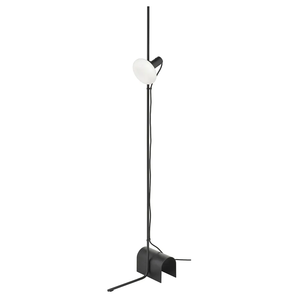 A black HÅRSLINGA floor lamp with a frosted glass bulb.