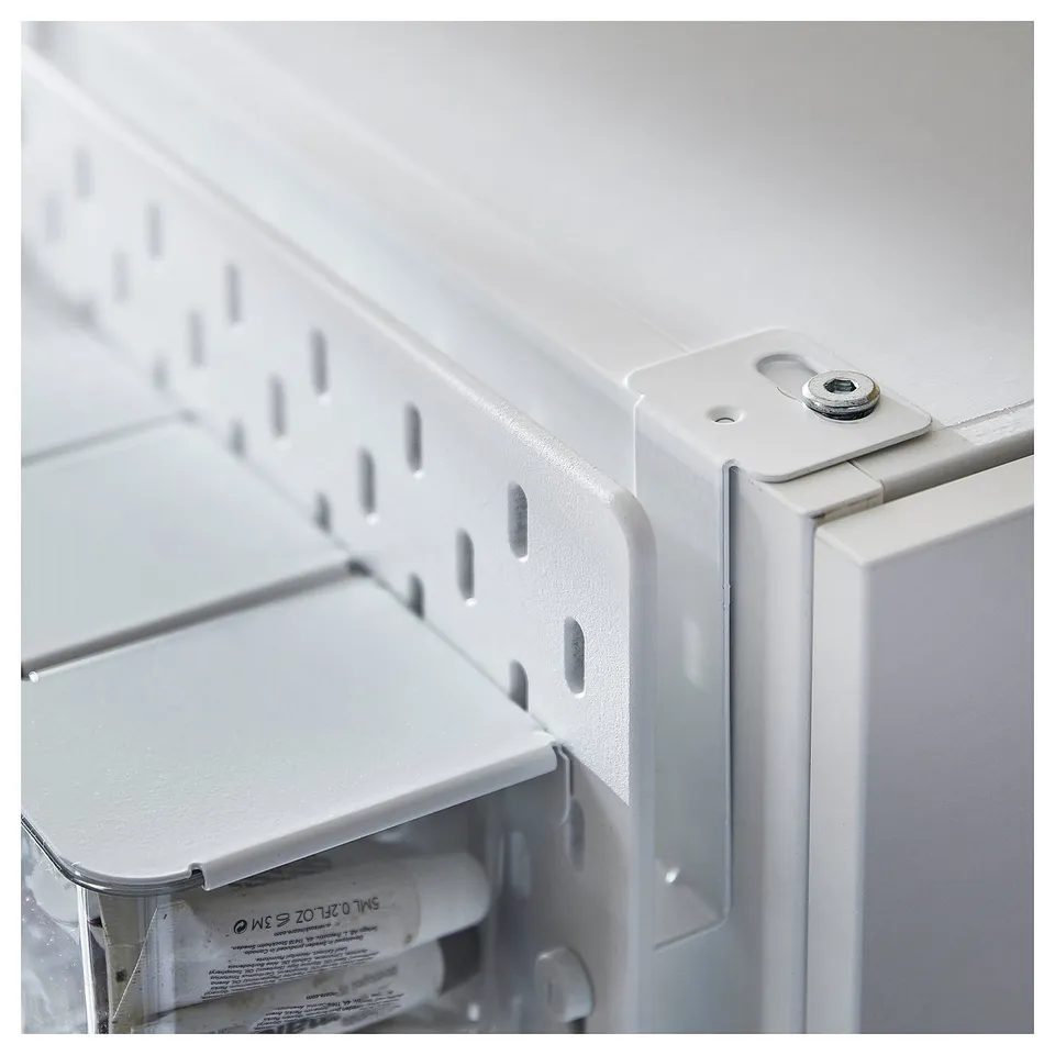 SKÅDIS connectors shown, metallic silver, attach pegboard to wardrobe sides.