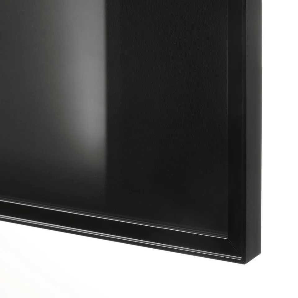 Close-up: sleek, black-finished HÖGBO glass door with shiny frame, part of billy bookcase.