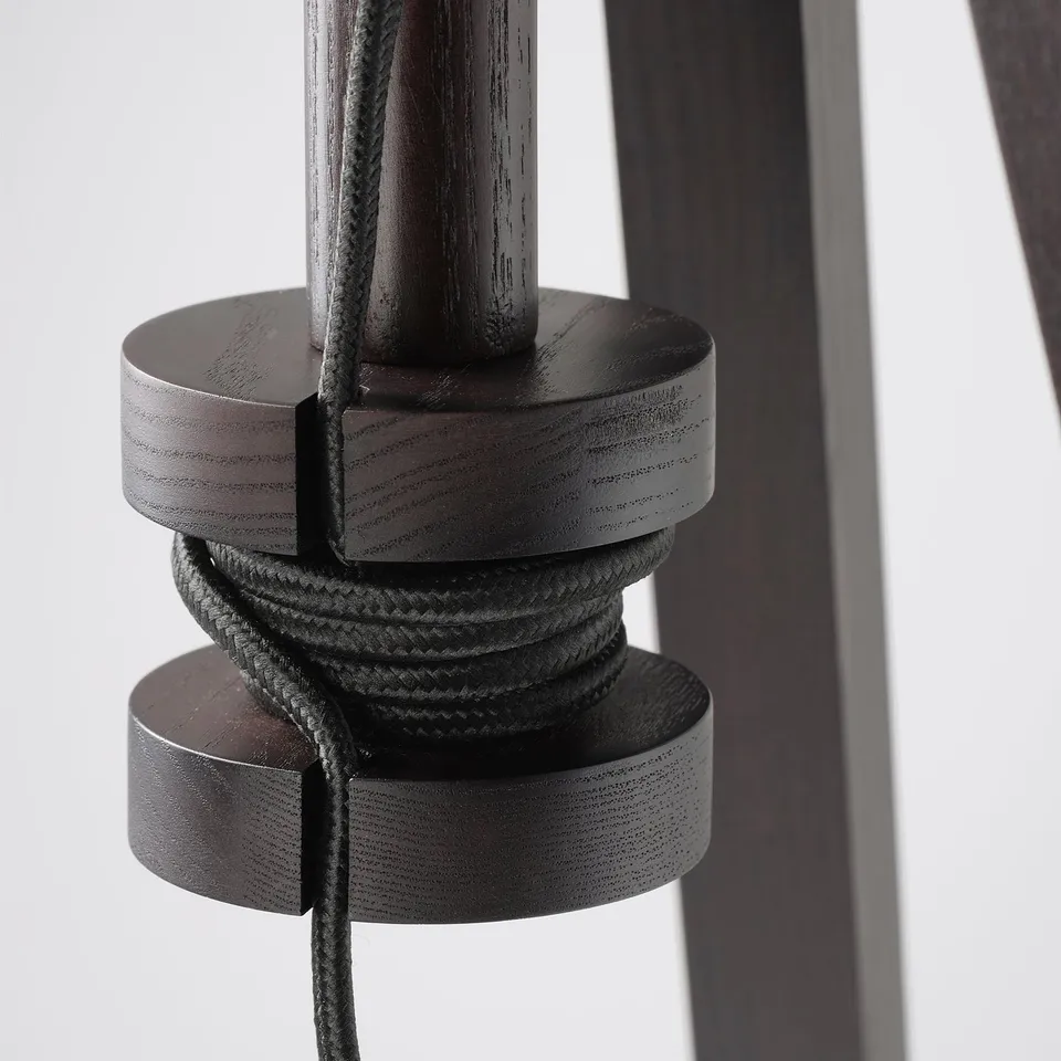 Dark wood lamp base with adjustable height, cord neatly wound around it.