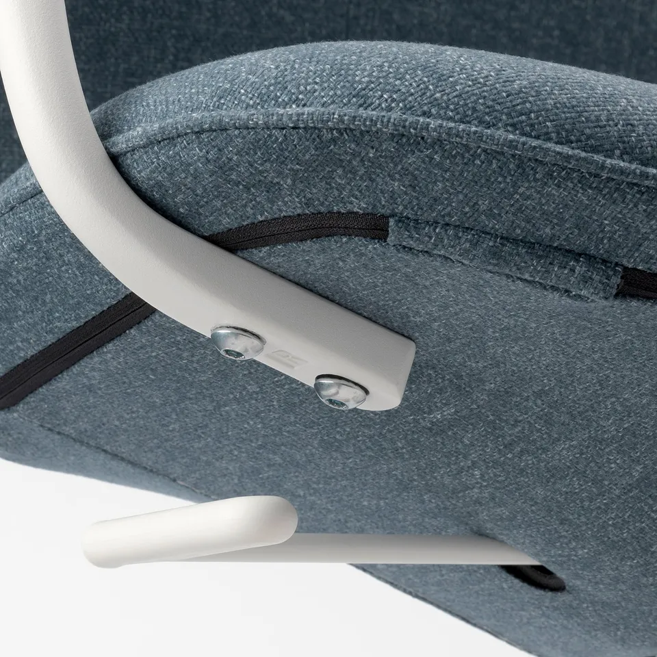 Close-up of modern office chairs seat and armrest, showing durable materials and high-quality stitching.