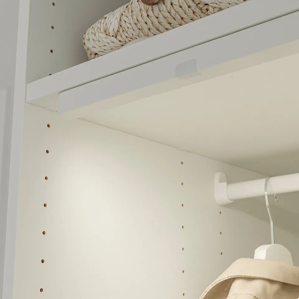 Image shows a LASTARE wardrobe. It includes a shelf with a basket, hooks, and adjustable shelves.