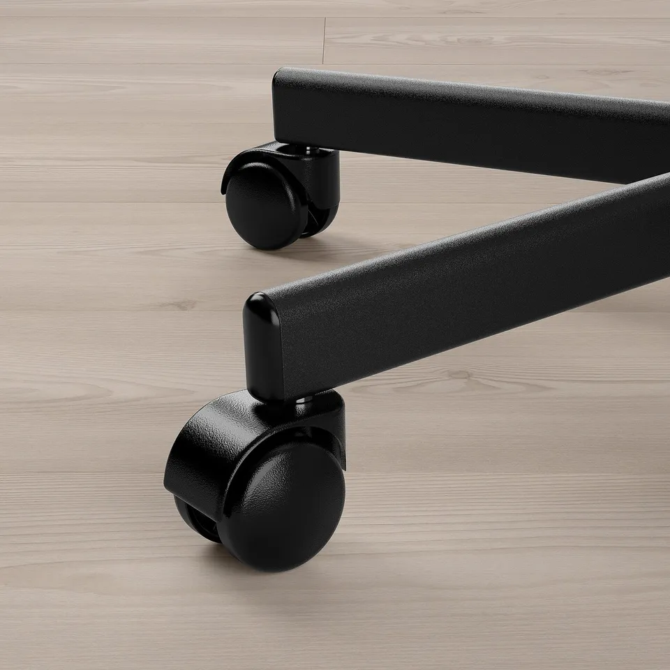 Black office chair wheels on light wooden floor. Close-up of castors and base, showing quality and design details.