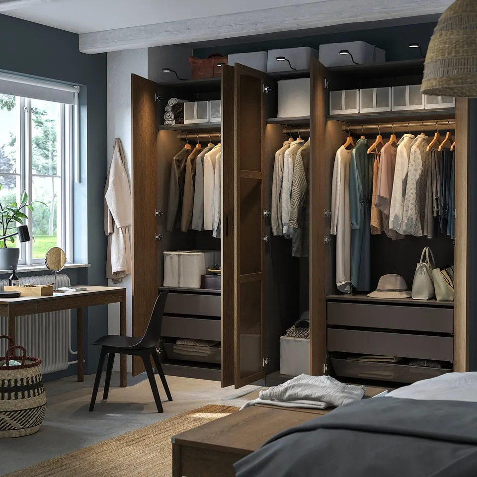 Open wooden closet in bedroom displays clothes hangers and shelves with accessories.