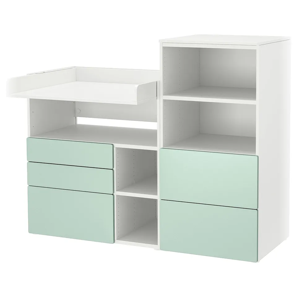Small white and light green changing table and storage unit with drawers and shelves. Modern and practical.