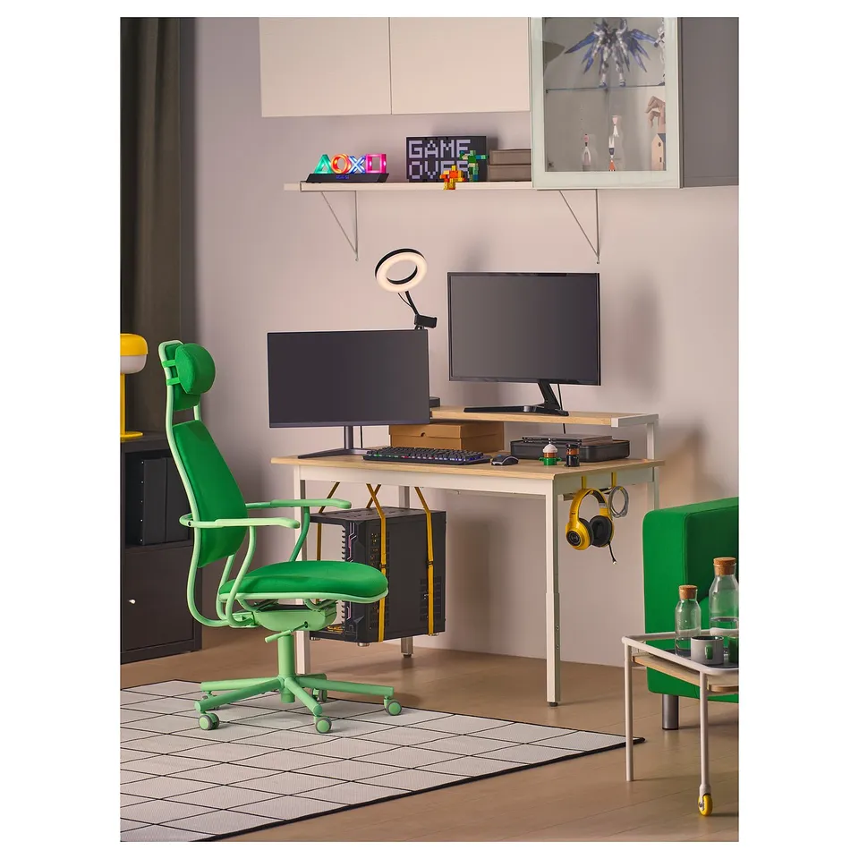 Gaming setup with neon green LÖPARBANA chair, white desk, dual monitors, and neon signs.