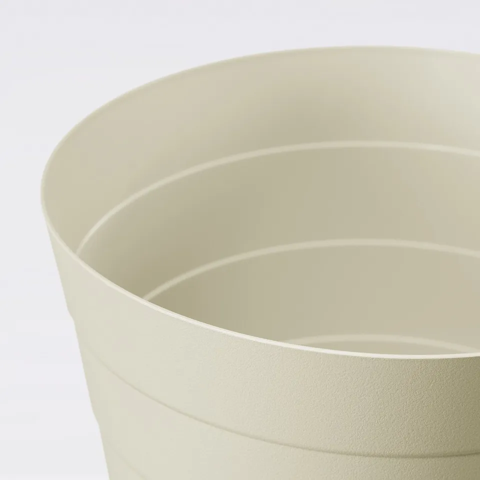 A large, light beige waste bin with smooth, curved edges, showcasing its clean and durable design.
