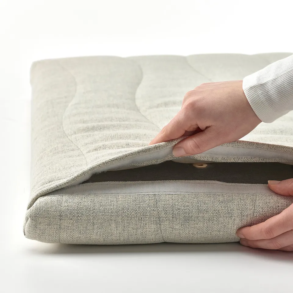 Hand fitting acoustic screen onto MITTZON desk, improving focus and sound absorption.