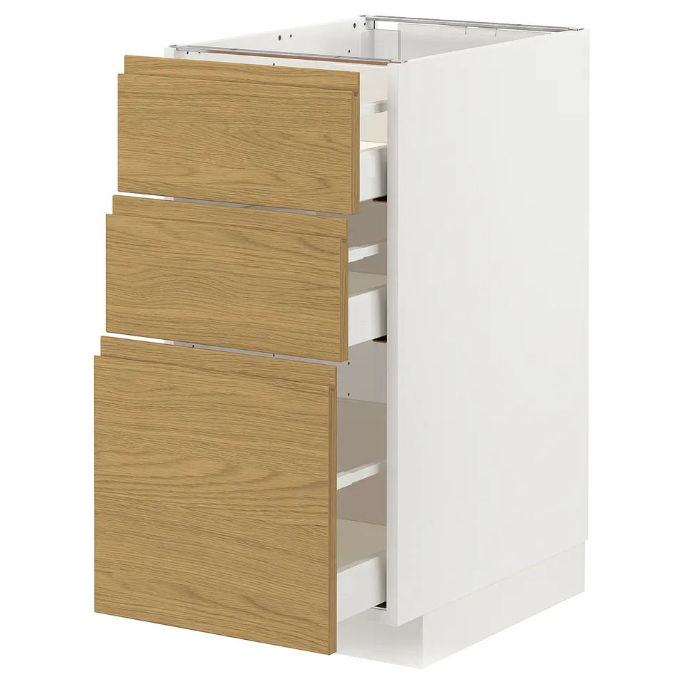 White METOD kitchen cabinet with three wooden drawers in a warm oak finish. Vertical, rectangular, and modern.